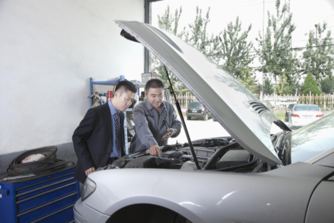 Men examining car engine: SBDPro Automotive Blog