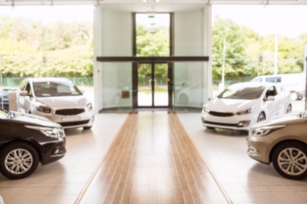 row of new cars in showroom