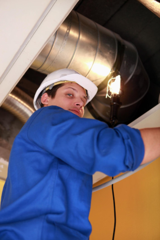 Man fixing heating system: SBDPro Small Business Blog